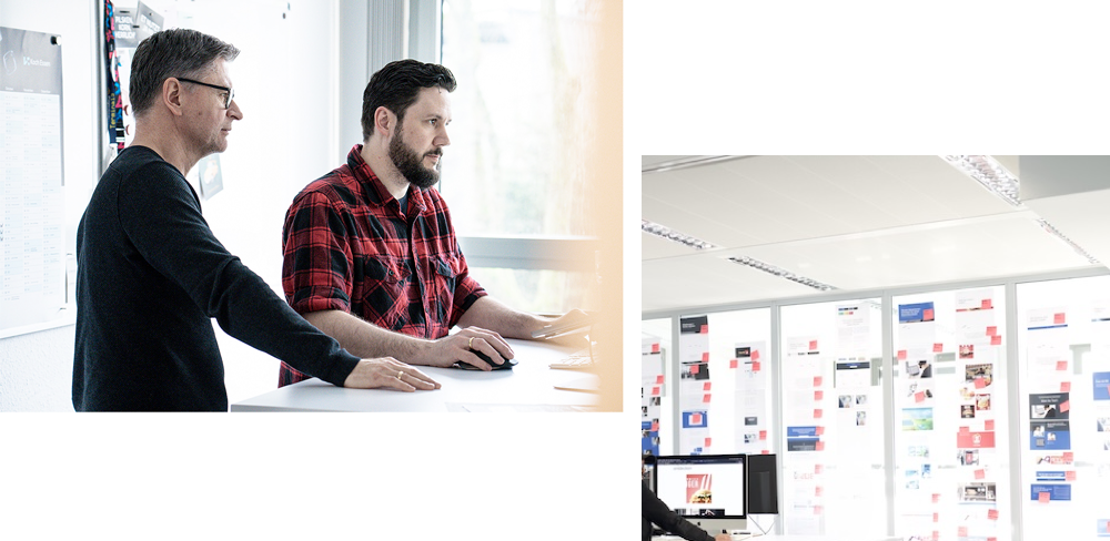 Employees at an agency work on computers